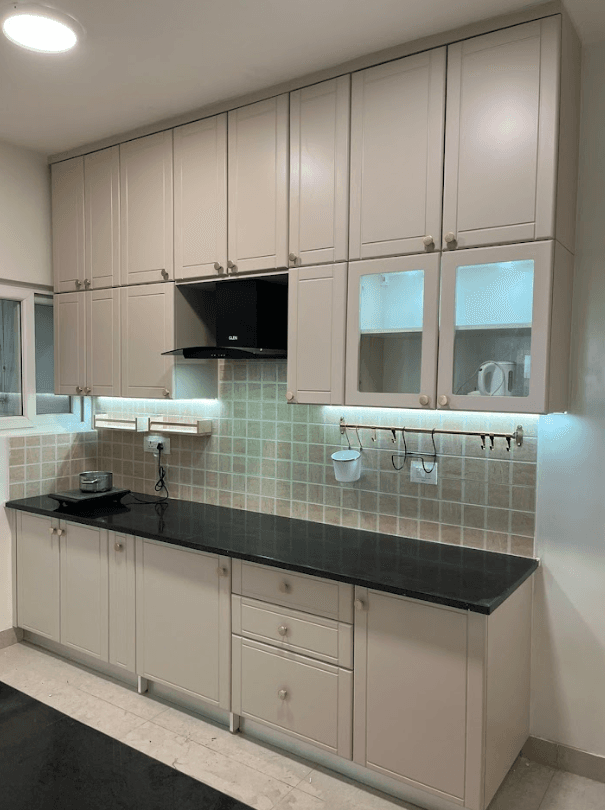 Modular kitchen with granite countertop and backlit cabinets